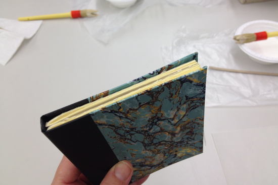 lining up the text block inside the book case before gluing the end papers inside