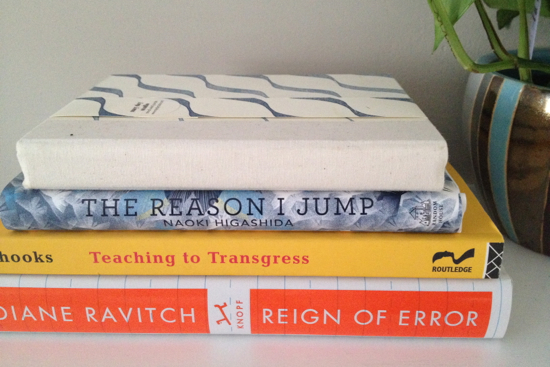 a few books related to education and one blank one