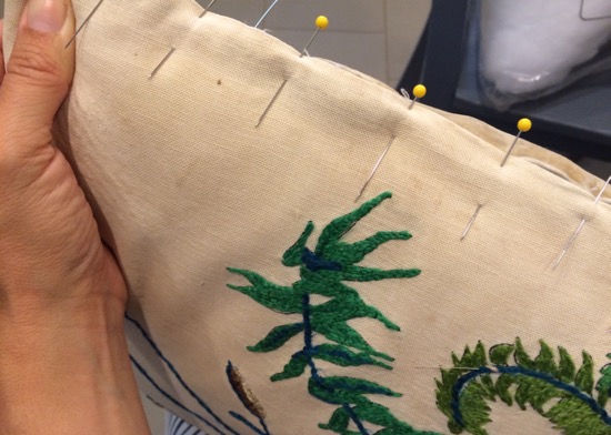 the pillow covering, clean though still stained and fragile with age